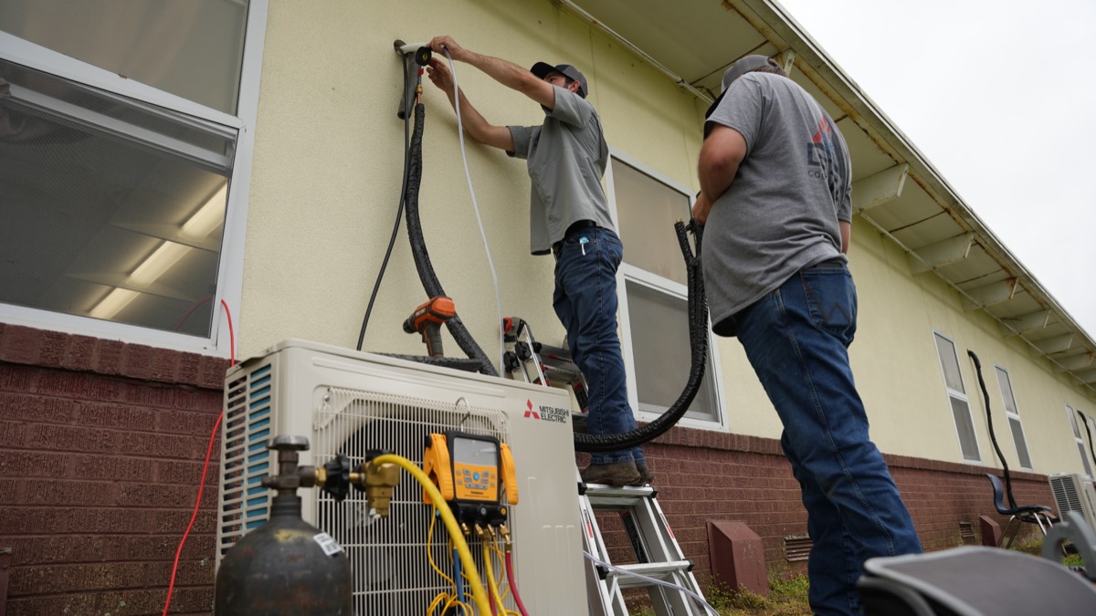 Delta Cooling technicians installing Mitsubishi heat pump in North Louisiana
